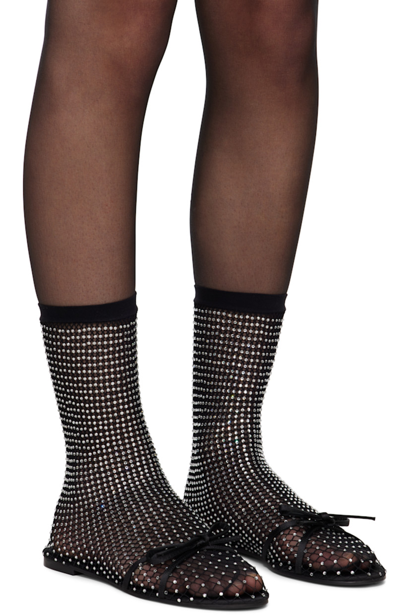 Semi-sheer mesh ballerina flats in black. Crystal-cut accents throughout.

· Bow accent at vamp
· Elasticized sock-style collar
· Unlined
· Rubber sole

Supplier color: Black