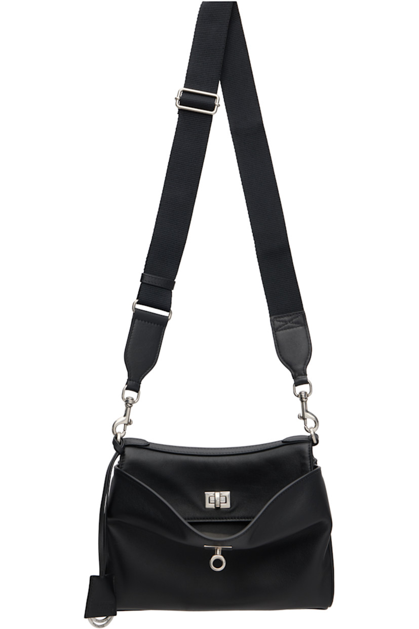 Buffed calfskin messenger bag. 

· Detachable leather crossbody strap
· Adjustable and detachable webbing crossbody strap
· Detachable logo-embossed sheathed keyrings
· Patch pockets at back face 
· Press-stud accordion panel at sides
· Patch pockets at back face
· Bumper studs at base
· Turn-lock flap 
· Zip pocket at two-compartment interior 
· Bonded nappa lambskin lining
· Logo-engraved antiqued silver-tone hardware
· H7" x W9.5" x D4"

Supplier color: Black