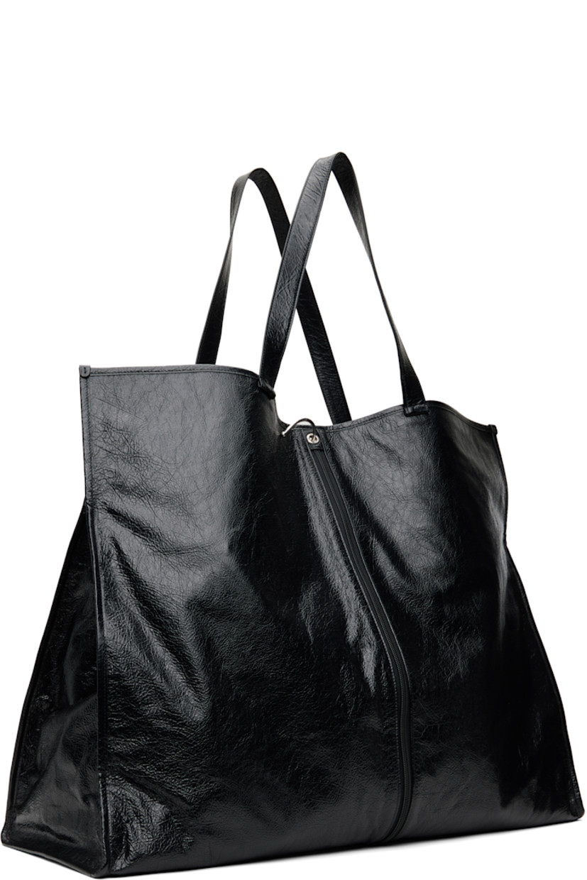 Crinkled patent lambskin tote in black.

· Twin shoulder straps
· Logo embossed at face
· Zip pocket at face
· Press-stud fastening at sides
· Hook toggle closure
· Zip pocket at interior
· Logo-woven taffeta lining
· Logo-engraved black hardware
· H19.5" x W25" x D9"

Supplier color: Black