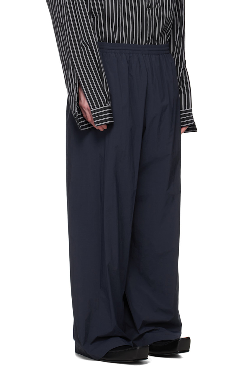 Nylon taffeta track pants.

· Mid-rise
· Concealed drawstring at elasticized waistband
· Two-pocket styling
· Logo embroidered at leg
· Full mesh lining

Supplier color: Navy