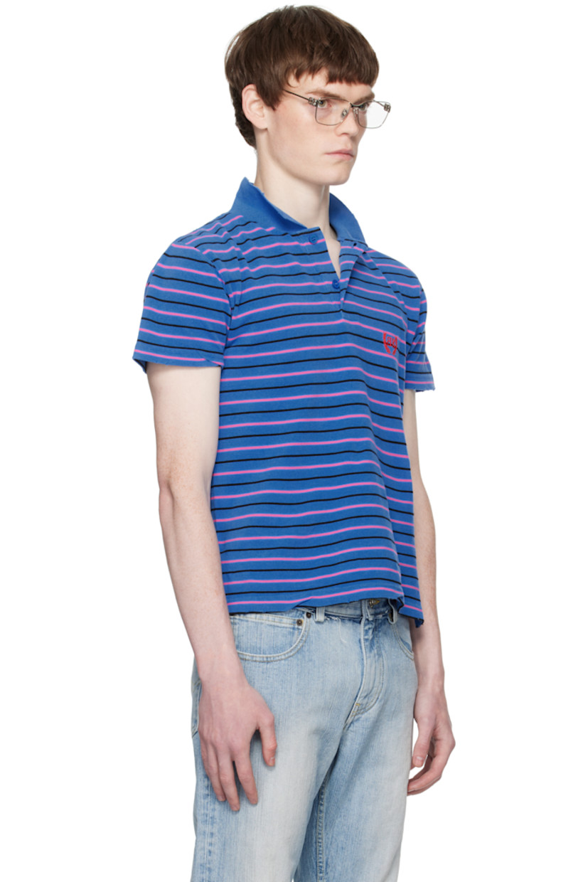 Cotton piqué polo.

· Distressing and stripes throughout
· Rib-knit spread collar
· Two-button placket
· Logo embroidered at chest
· Tennis-tail hem

Supplier color: Blue/Pink/Black