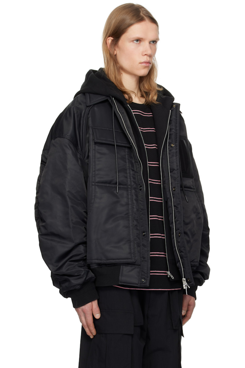 Padded nylon taffeta bomber jacket.

· Drawstring at detachable hood
· Spread collar
· Two-way zip closure with press-stud placket
· Flap pocket and patch pockets
· Pen slots and embossed logo at chest
· Rib-knit hem and cuffs
· Dropped shoulders
· Welt pocket at interior
· Full satin lining

Supplier color: Black