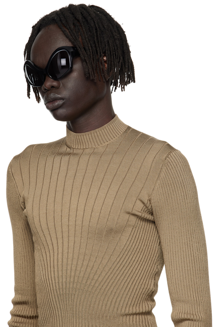 Modified cat-eye acetate-frame sunglasses.

· Integrated nose pads
· Black lenses with 100% UVA/UVB protection
· Logo etched at temples
· Hardware at temple tips
· Titanium hardware
· Logo-embossed squeeze-top pouch
· Size: 58.20 120

Supplier color: Black