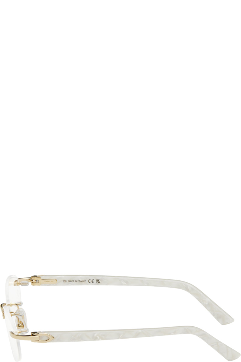 Oval rimless metal- and acetate-frame optical glasses in gold tone and white. 

· Adjustable rubber nose pads
· Logo hardware at temples
· Includes case 
· Size: 52.16 135

Supplier color: Gold