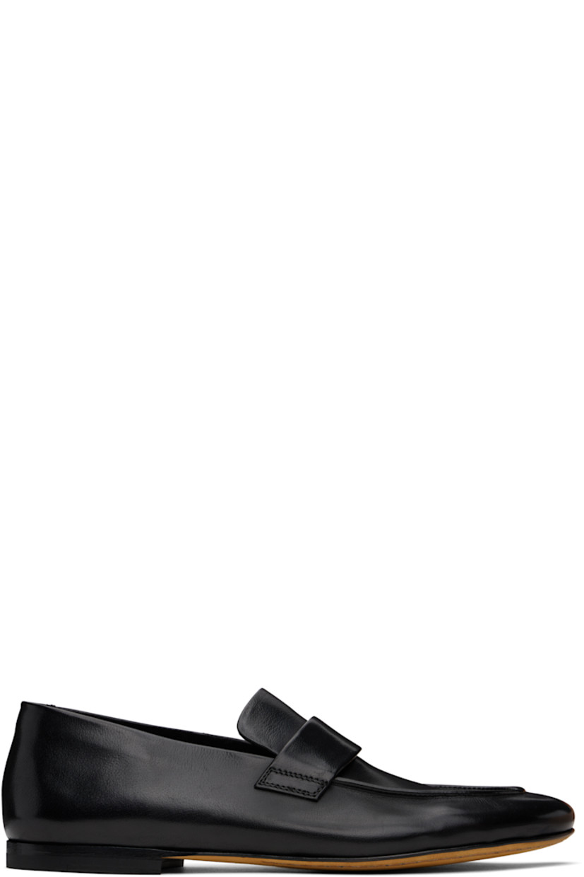 Handcrafted vegetable-tanned grained leather loafers in black.

· Moc toe
· Strap at vamp
· Logo embossed at grained leather footbed
· Stacked leather heel with rubber injection
· Suede sole

Supplier color: Black