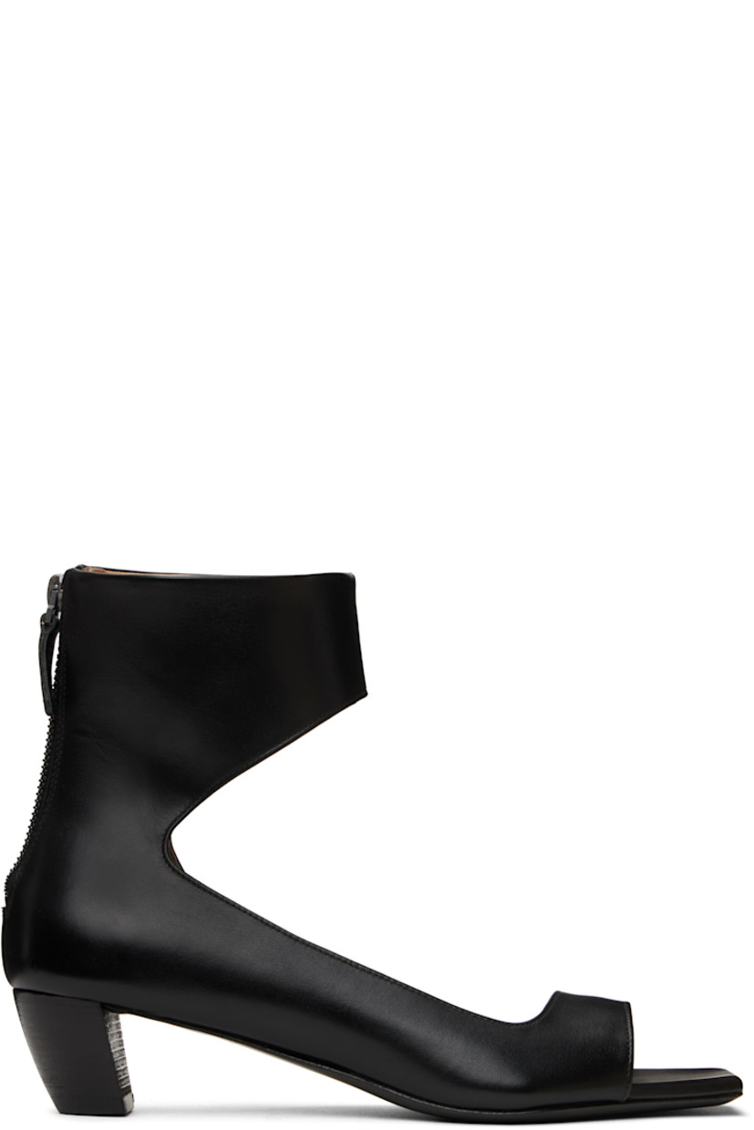 Buffed calfskin heeled sandals in black. 

· Open square toe
· Strap at vamp and ankle
· Zip closure at heel
· Logo embossed at padded leather footbed
· Grained leather lining
· Stacked leather heel with rubber injection
· Polished leather sole
· Heel: H1.5"

Supplier color: Black