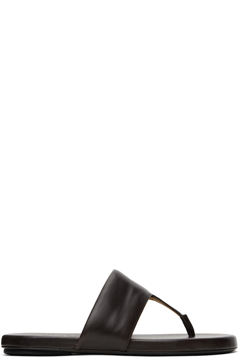Grained leather flat sandals in brown.

· Open toe
· Padded thong-style strap at vamp
· Logo embossed at padded leather footbed
· Hand-painted leather sole with rubber injection

Supplier color: Dark brown