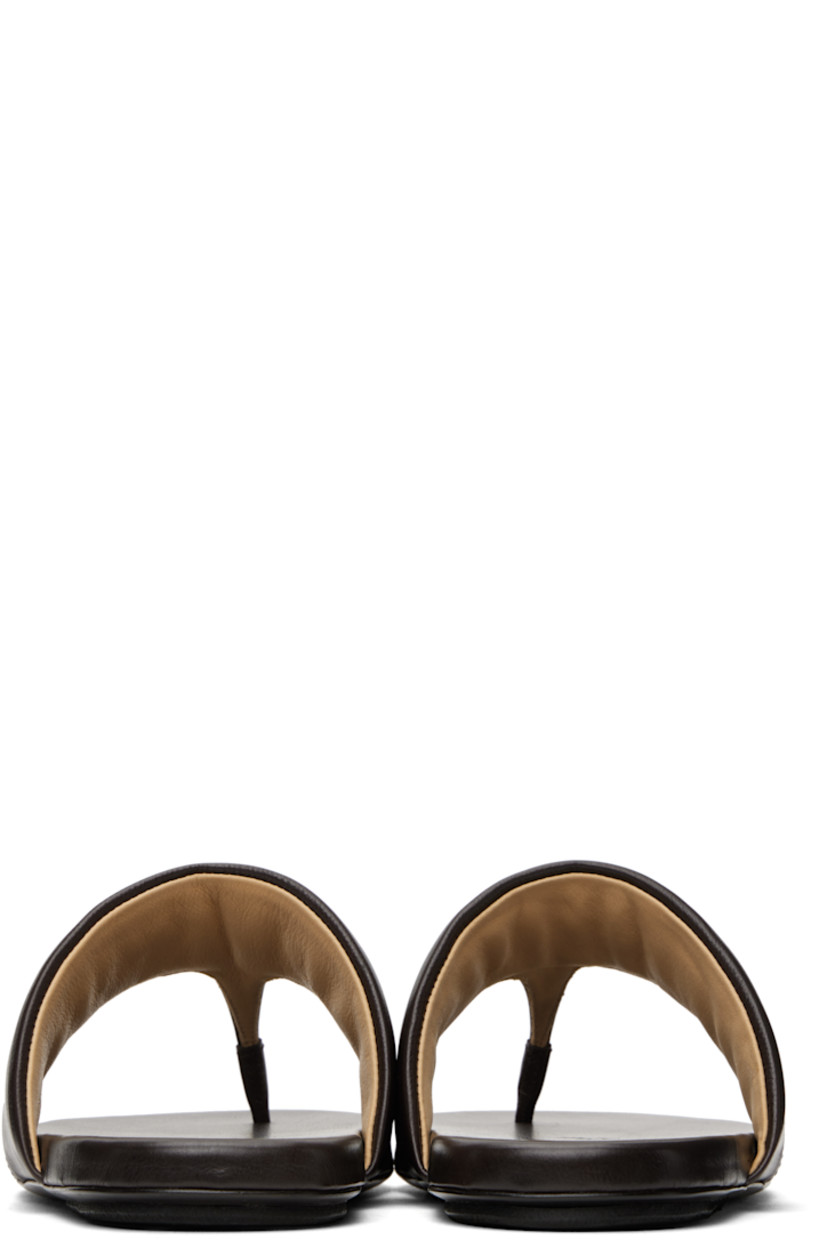 Grained leather flat sandals in brown.

· Open toe
· Padded thong-style strap at vamp
· Logo embossed at padded leather footbed
· Hand-painted leather sole with rubber injection

Supplier color: Dark brown