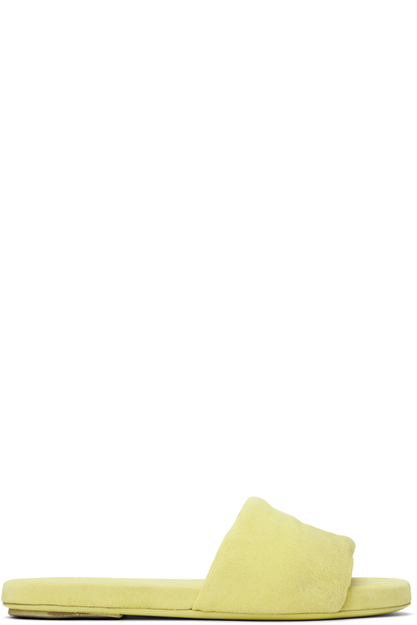 Calfskin suede slip-on flat sandals in green. 

· Padded strap at vamp
· Logo embossed at padded footbed
· Grained leather lining
· Hand-dyed leather sole with rubber injection

Supplier color: Chlorine