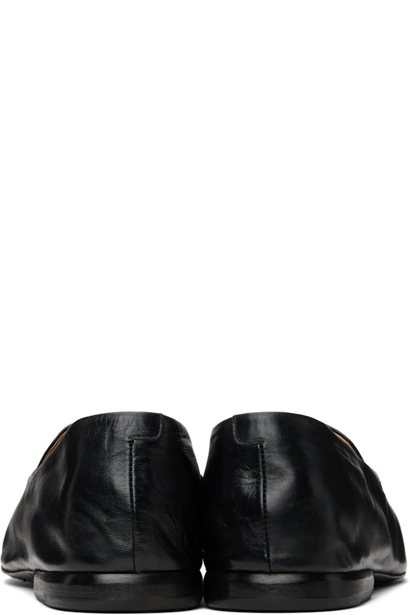 Crinkled grained calfskin loafers in black. 

· Topstitching at moc toe
· Logo embossed at padded footbed
· Suede and buffed leather lining
· Stacked leather heel with rubber injection
· Leather sole

Supplier color: Black