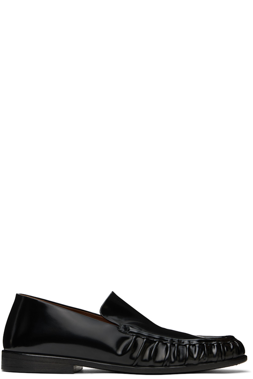 Handcrafted patent calfskin loafers in black. 

· Gathering at moc toe
· Suede and buffed leather lining
· Stacked leather heel with rubber injection
· Hand-dyed leather sole

Supplier color: Black