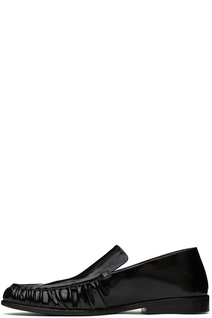Handcrafted patent calfskin loafers in black. 

· Gathering at moc toe
· Suede and buffed leather lining
· Stacked leather heel with rubber injection
· Hand-dyed leather sole

Supplier color: Black