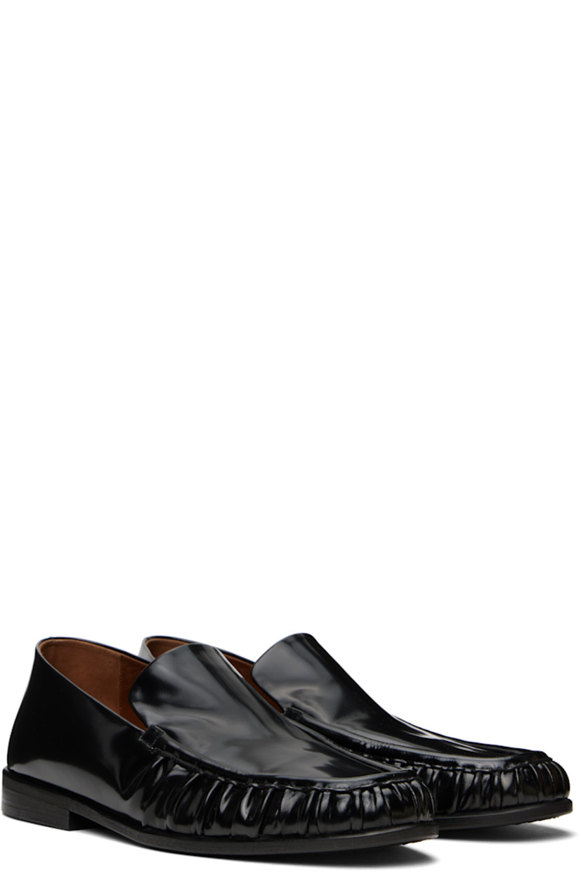 Handcrafted patent calfskin loafers in black. 

· Gathering at moc toe
· Suede and buffed leather lining
· Stacked leather heel with rubber injection
· Hand-dyed leather sole

Supplier color: Black