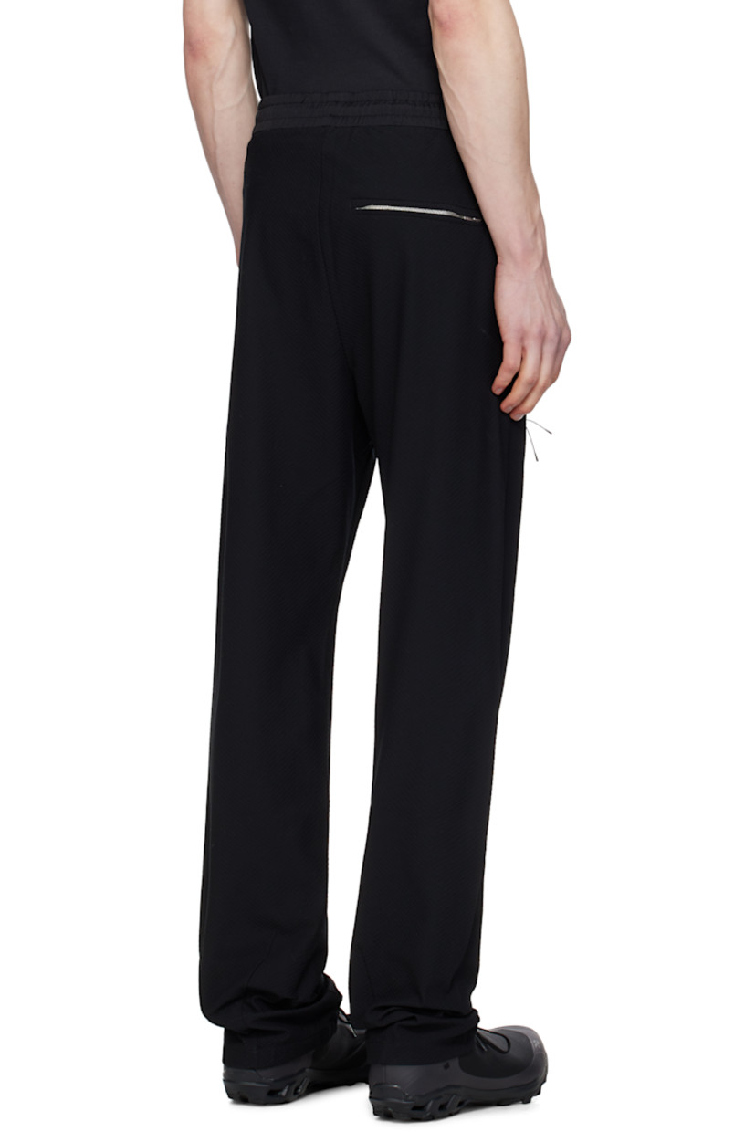 Lightweight TEXBRID™ polyester jersey track pants. Jacquard check pattern throughout.

· Drawstring at elasticized waistband
· Three-pocket styling
· Zip fly
· Dart at front leg and back cuffs
· Concealed zip pocket at leg
· Partially elasticized cuffs

Part of the 8.0 collection.  

Supplier color: Black