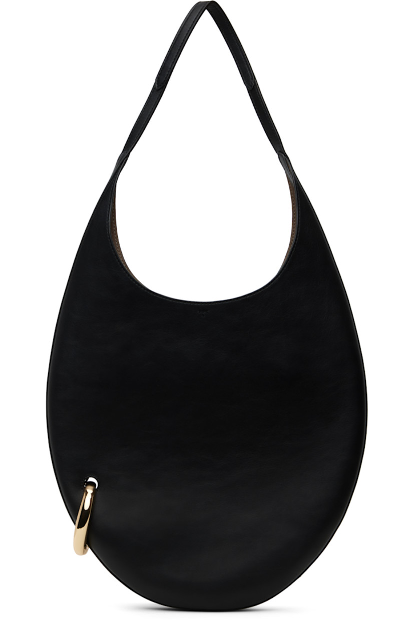 Buffed leather shoulder bag in black.

· Fixed shoulder strap
· Gold-tone O-ring at side
· Self-tie closure
· Zip pocket at interior
· Faux-suede lining
· H12" x W12.5" x D1"
· Total height: H23"
 
Supplier color: Black/Gold