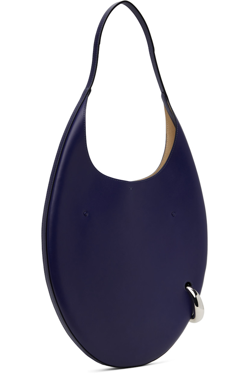Buffed leather shoulder bag in navy.

· Fixed shoulder strap
· Silver-tone O-ring at side
· Self-tie closure
· Zip pocket at interior
· Faux-suede lining
· H12" x W12.5" x D1"
· Total height: H23"
 
Supplier color: Ballpoint blue
