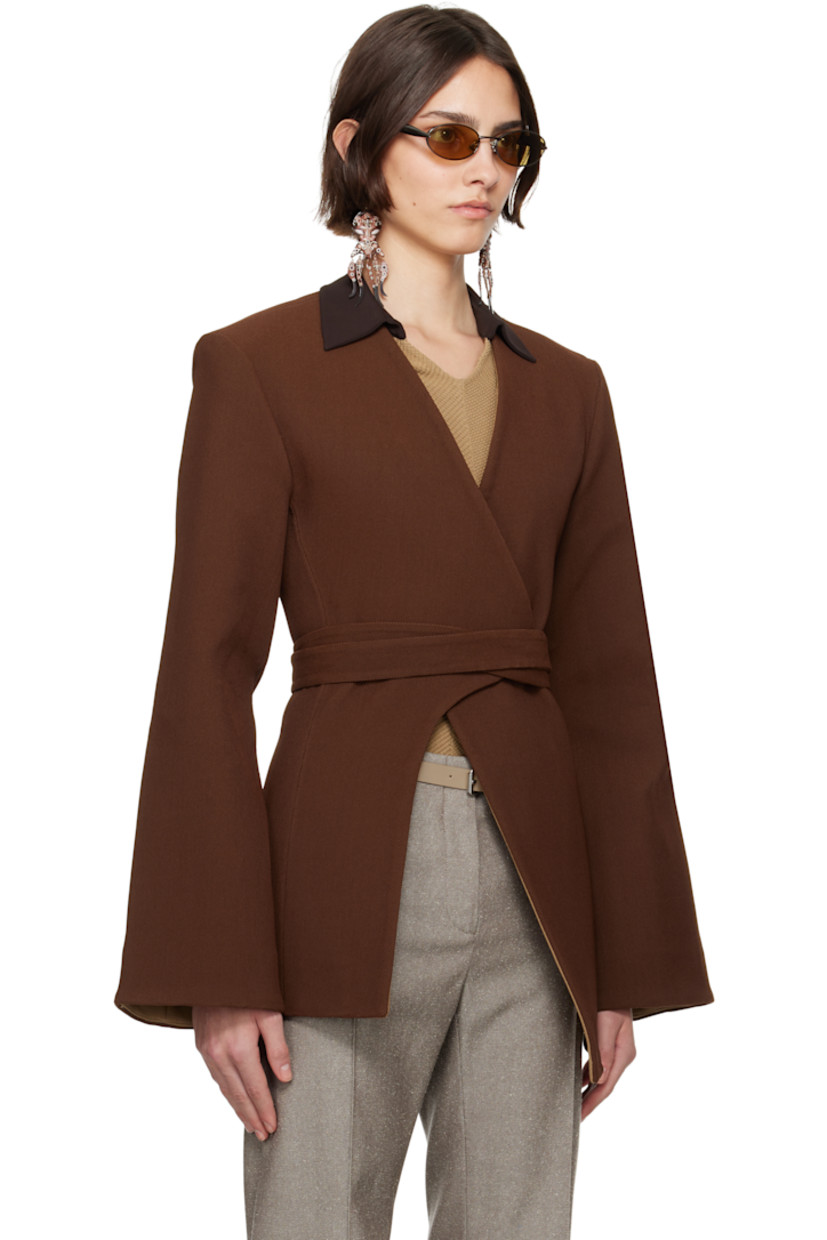 Stretch nylon-blend piqué blazer.

· Wrap construction
· Y-neck
· Hook-eye wraparound belt
· Asymmetric hem
· Padded shoulders
· Darts at back
· Partial plain-woven lining

Supplier color: Spiced mocha