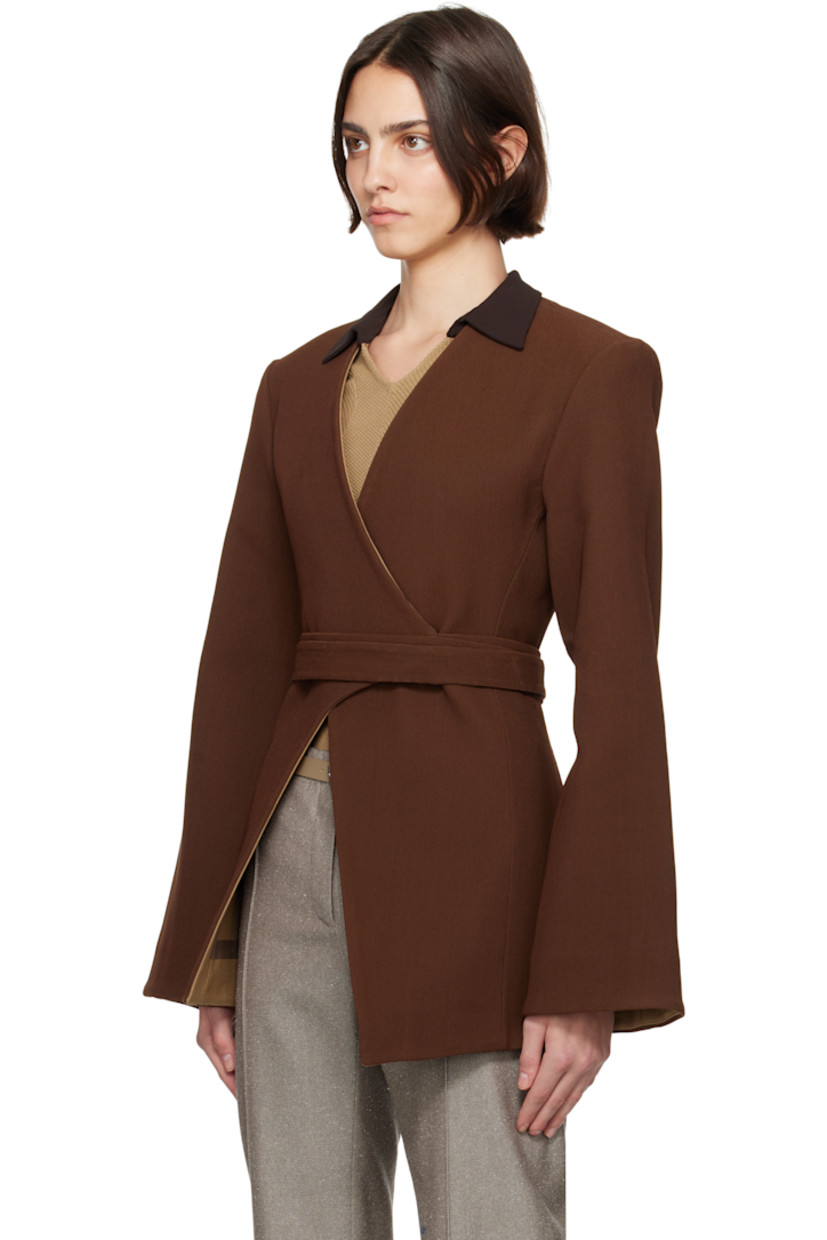 Stretch nylon-blend piqué blazer.

· Wrap construction
· Y-neck
· Hook-eye wraparound belt
· Asymmetric hem
· Padded shoulders
· Darts at back
· Partial plain-woven lining

Supplier color: Spiced mocha