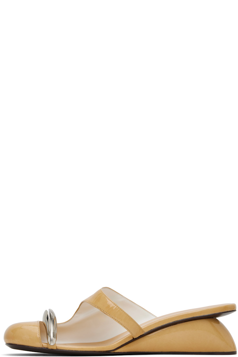 Patent goatskin mules in beige.

· Cutout at vamp
· Silver-tone hardware at toe strap
· Logo stamp at padded footbed
· Covered wedge heel with rubber injection
· Polished leather sole
· Heel: H2"

Supplier color: Cantucci/Silver
