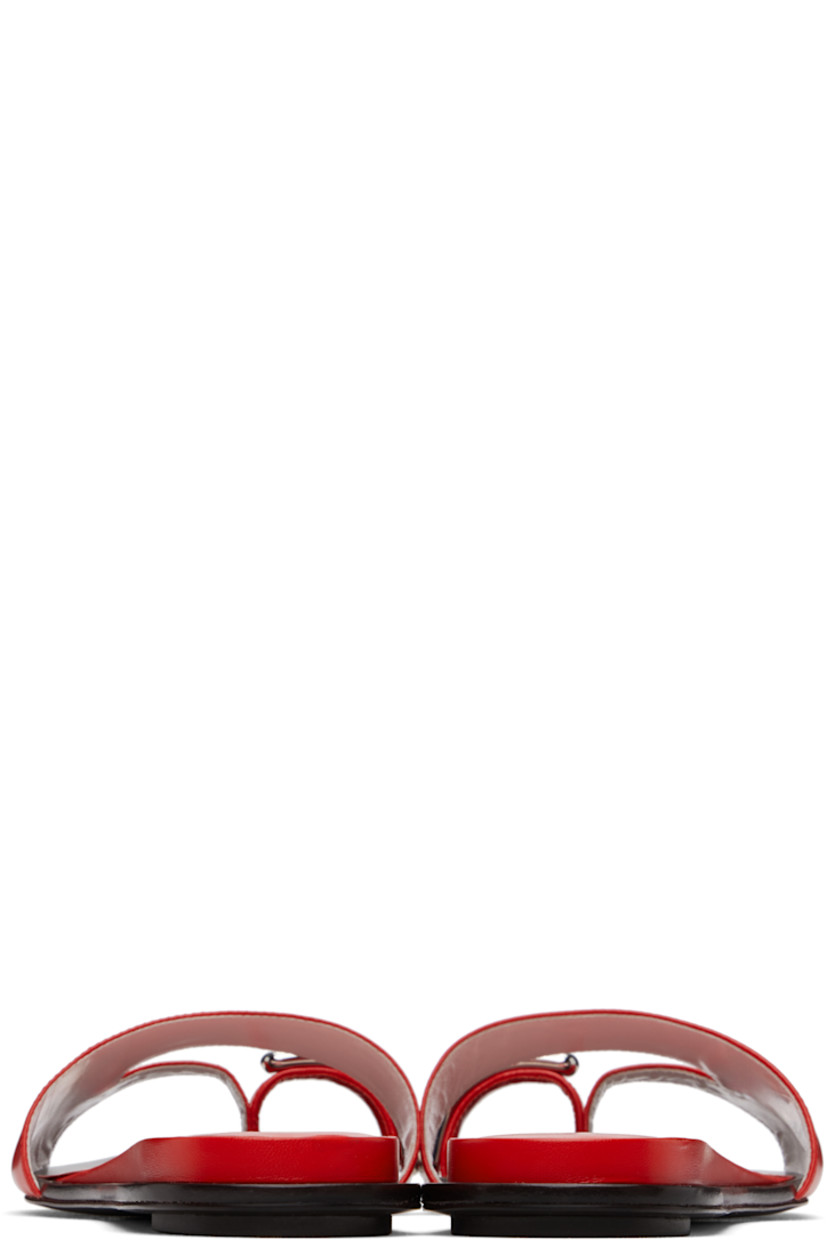 Buffed goatskin flat sandals in red.

· Open toe
· Silver-tone hardware at toe strap
· Cutout at vamp
· Logo stamp at padded goatskin footbed
· Covered midsole
· Polished leather sole with rubber injection

Supplier color: Blazing red/Silver