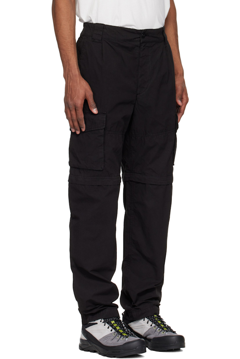 Garment-dyed cotton canvas cargo pants.

· Loose-fit
· Belt loops at partially elasticized waistband
· Three-pocket styling
· Zip fly
· Pleats at front
· Concealed bungee-style drawstring at knees
· Detachable zip panel at knees for shorts styling
· Flap pockets at outseam
· Cargo pocket at outseam
· Logo patch at back

Supplier color: Black