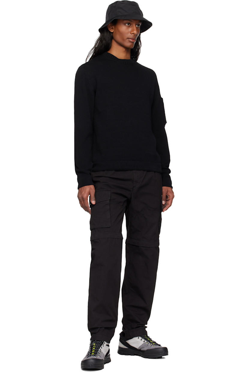 Garment-dyed cotton canvas cargo pants.

· Loose-fit
· Belt loops at partially elasticized waistband
· Three-pocket styling
· Zip fly
· Pleats at front
· Concealed bungee-style drawstring at knees
· Detachable zip panel at knees for shorts styling
· Flap pockets at outseam
· Cargo pocket at outseam
· Logo patch at back

Supplier color: Black