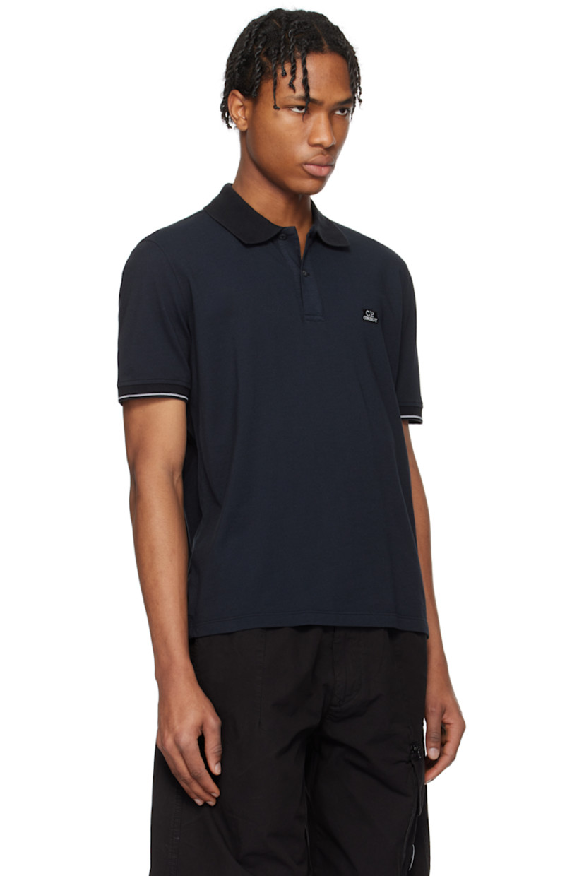 Garment-dyed cotton- and nylon-blend piqué polo.

· Rib-knit spread collar and cuffs
· Two-button placket
· Embroidered logo patch at chest
· Tennis-tail hem
· Stripe at cuffs

Supplier color: Black