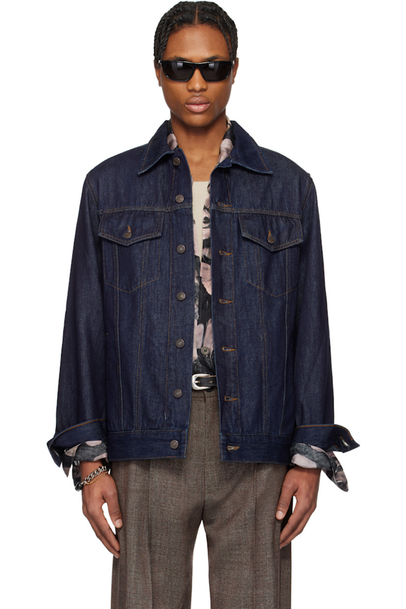 Paneled non-stretch denim jacket.

· Spread collar
· Button closure
· Flap and welt pockets
· Adjustable single-button barrel cuffs
· Logo-engraved bronze-tone hardware
· Contrast stitching in tan

Supplier color: Indigo