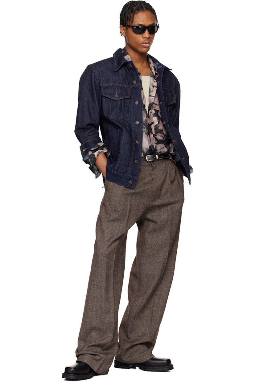 Paneled non-stretch denim jacket.

· Spread collar
· Button closure
· Flap and welt pockets
· Adjustable single-button barrel cuffs
· Logo-engraved bronze-tone hardware
· Contrast stitching in tan

Supplier color: Indigo