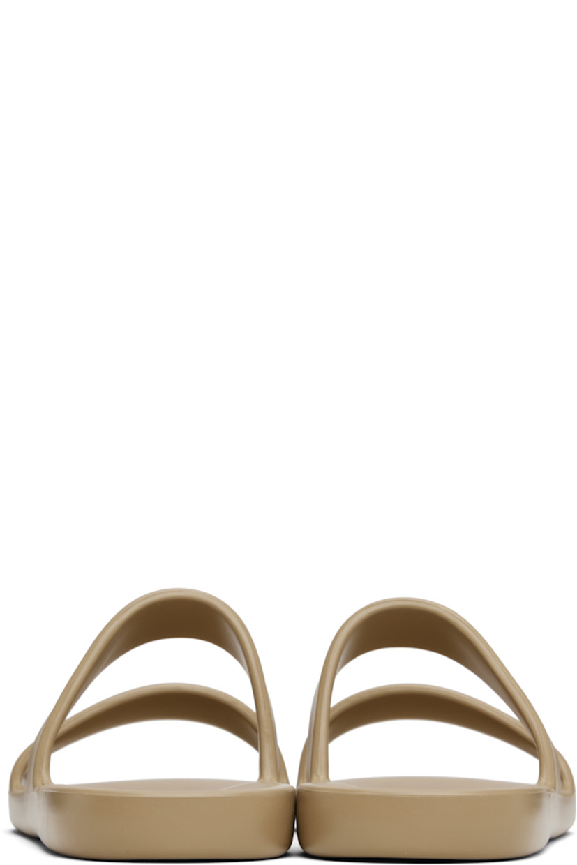 Lightweight foam rubber flat sandals in taupe.

· Open toe
· Logo embossed at molded footbed
· Treaded foam rubber sole

Supplier color: Iron grey