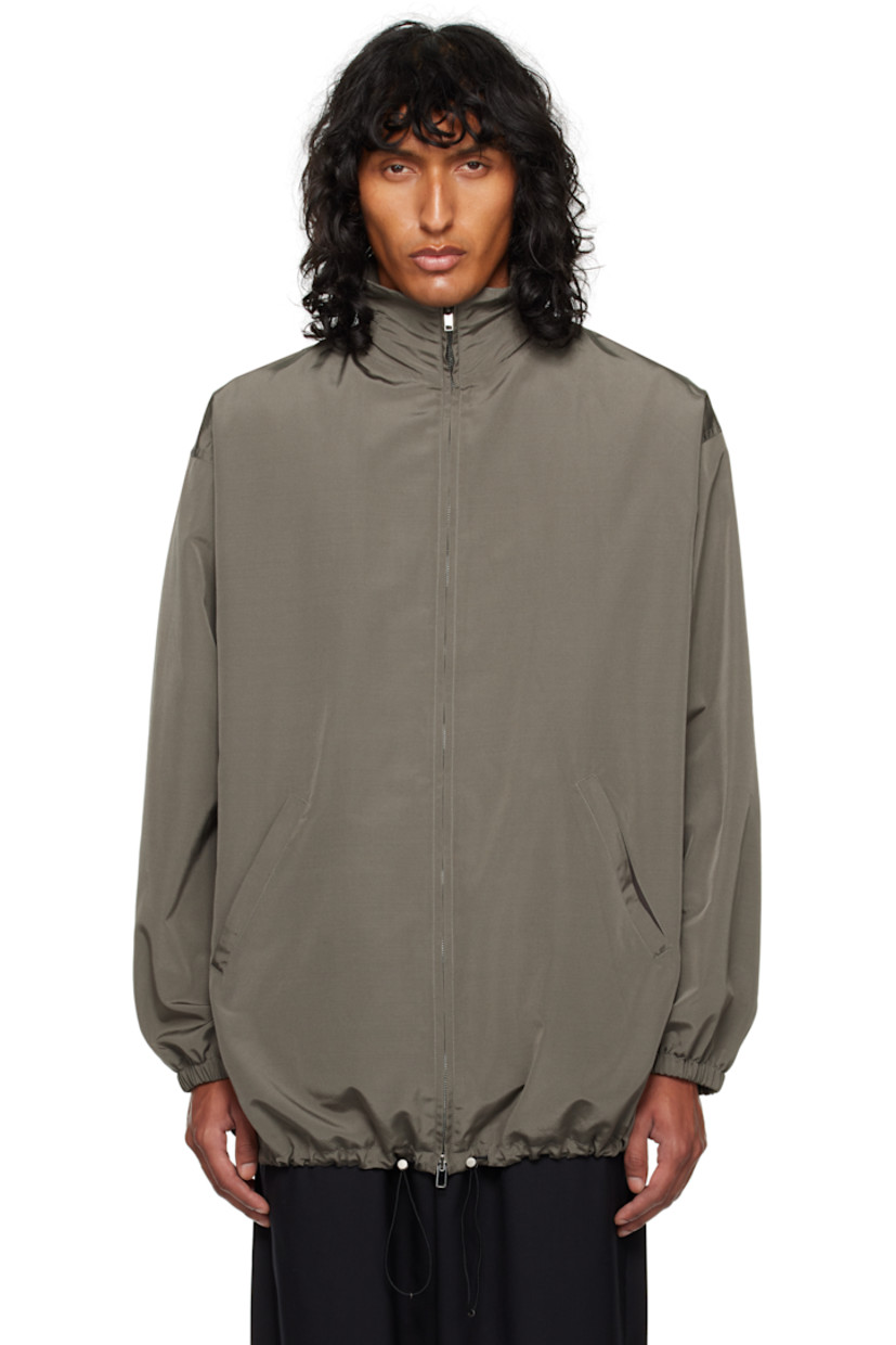 Silk- and wool-blend faille jacket.

· Stowaway hood at funnel neck
· Two-way zip closure
· Welt pockets
· Bungee-style drawstring at hem
· Elasticized cuffs
· Welt pocket at interior
· Full cashmere jersey lining

Supplier color: Grey sepia