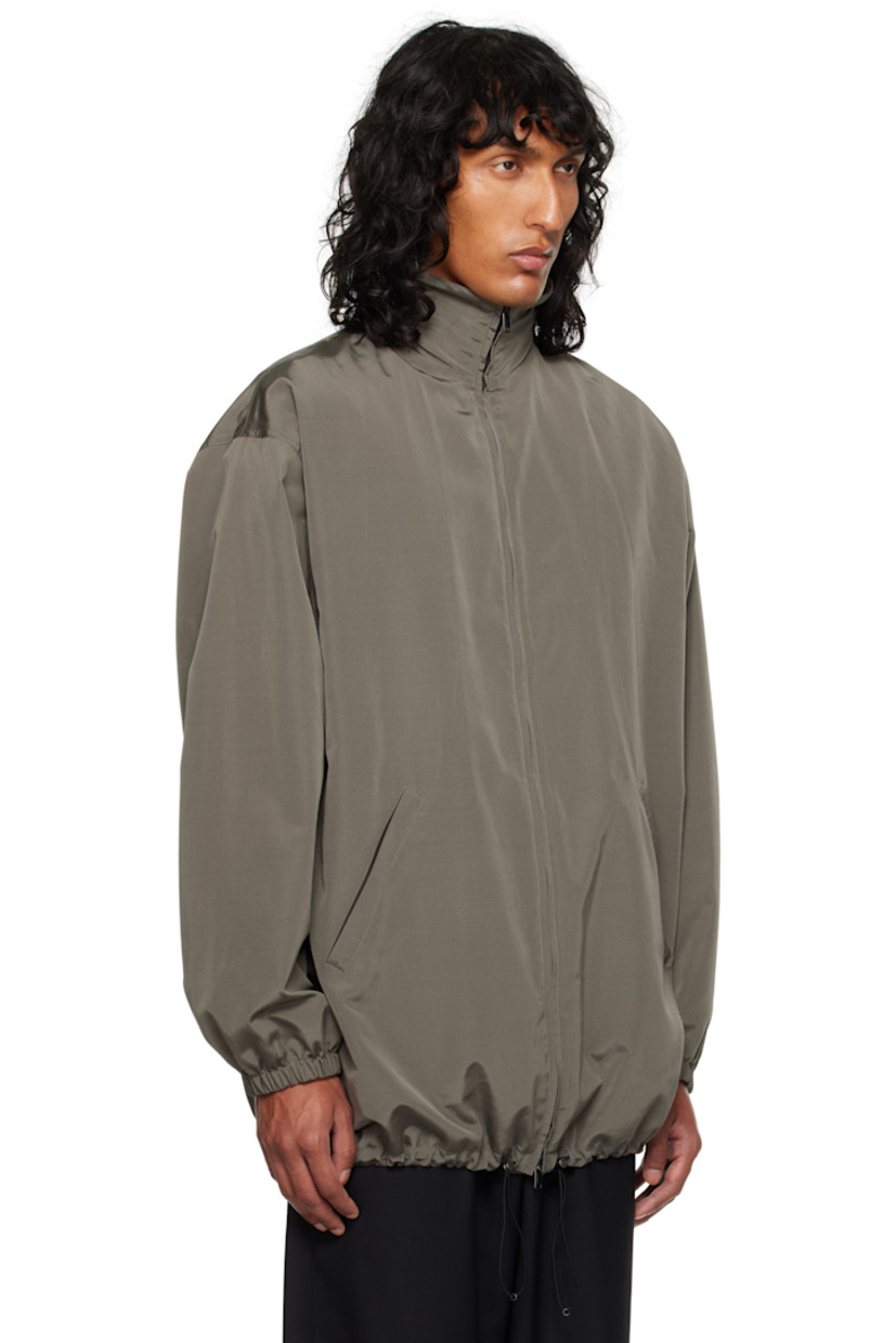 Silk- and wool-blend faille jacket.

· Stowaway hood at funnel neck
· Two-way zip closure
· Welt pockets
· Bungee-style drawstring at hem
· Elasticized cuffs
· Welt pocket at interior
· Full cashmere jersey lining

Supplier color: Grey sepia