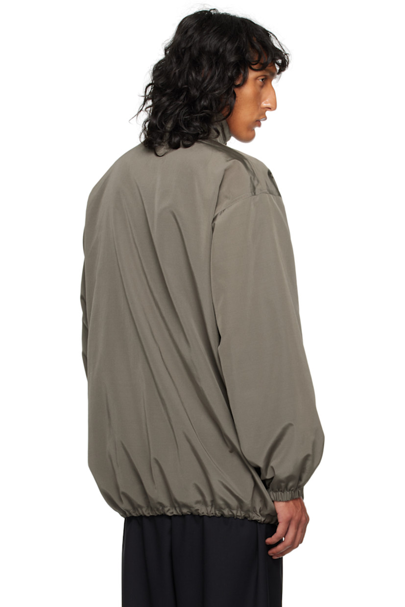 Silk- and wool-blend faille jacket.

· Stowaway hood at funnel neck
· Two-way zip closure
· Welt pockets
· Bungee-style drawstring at hem
· Elasticized cuffs
· Welt pocket at interior
· Full cashmere jersey lining

Supplier color: Grey sepia