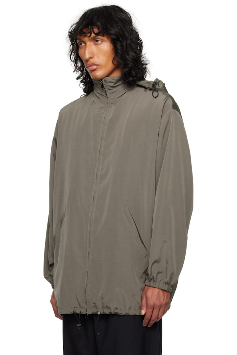 Silk- and wool-blend faille jacket.

· Stowaway hood at funnel neck
· Two-way zip closure
· Welt pockets
· Bungee-style drawstring at hem
· Elasticized cuffs
· Welt pocket at interior
· Full cashmere jersey lining

Supplier color: Grey sepia
