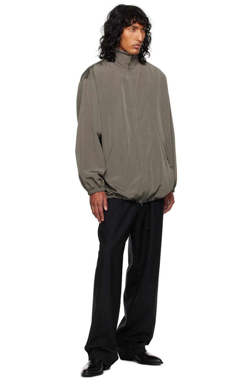 Silk- and wool-blend faille jacket.

· Stowaway hood at funnel neck
· Two-way zip closure
· Welt pockets
· Bungee-style drawstring at hem
· Elasticized cuffs
· Welt pocket at interior
· Full cashmere jersey lining

Supplier color: Grey sepia