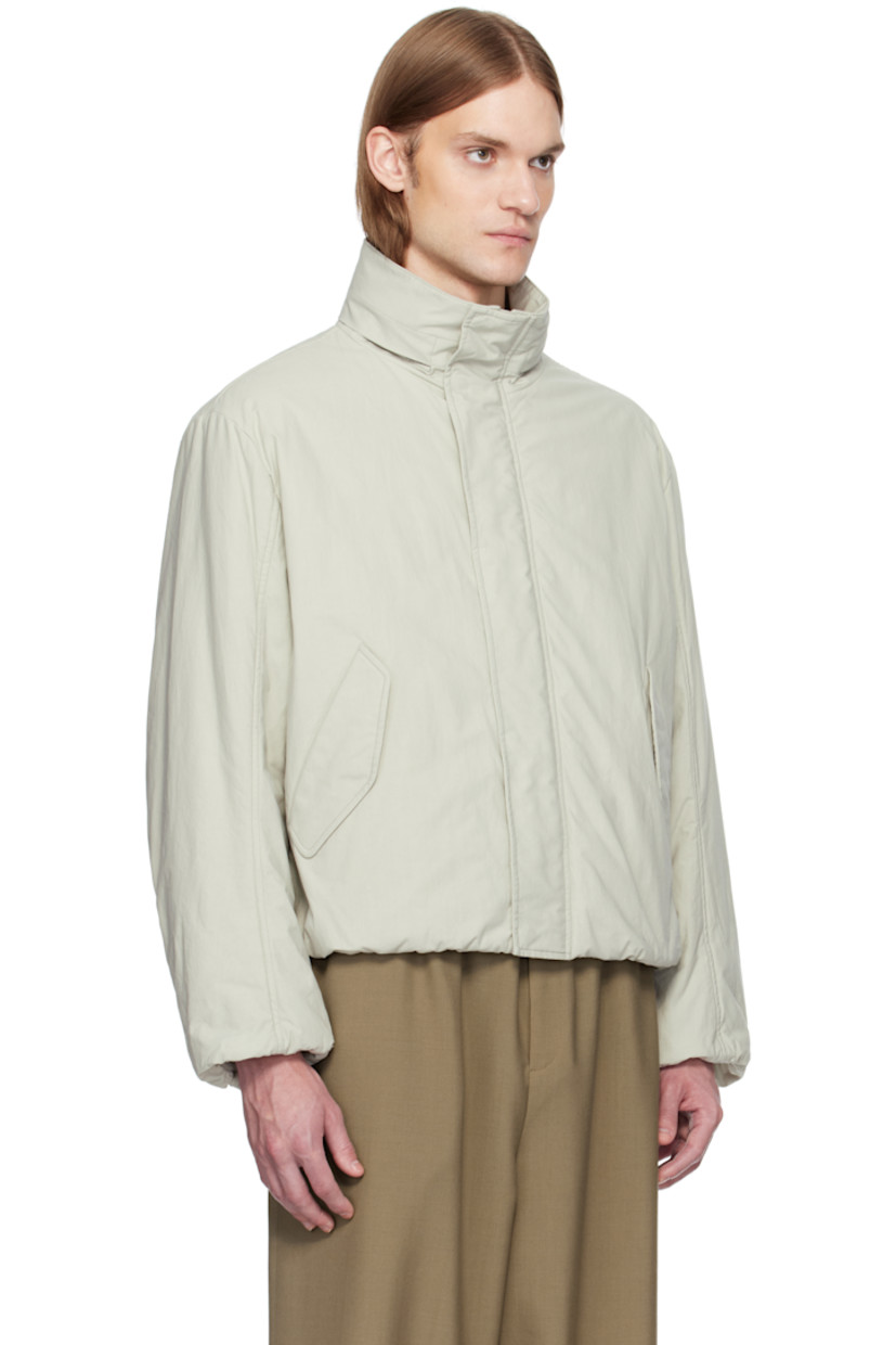 Padded heavyweight cotton poplin jacket. 

· Bungee-style drawstring at hood
· Stand collar
· Two-way zip closure with press-stud placket
· Flap pockets
·  Inset rib-knit hem and cuffs
· Dropped shoulders
· Welt pockets at interior

Supplier color: Stone