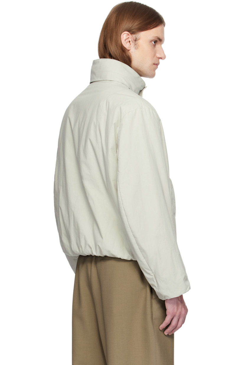Padded heavyweight cotton poplin jacket. 

· Bungee-style drawstring at hood
· Stand collar
· Two-way zip closure with press-stud placket
· Flap pockets
·  Inset rib-knit hem and cuffs
· Dropped shoulders
· Welt pockets at interior

Supplier color: Stone