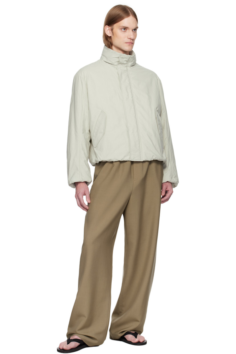 Padded heavyweight cotton poplin jacket. 

· Bungee-style drawstring at hood
· Stand collar
· Two-way zip closure with press-stud placket
· Flap pockets
·  Inset rib-knit hem and cuffs
· Dropped shoulders
· Welt pockets at interior

Supplier color: Stone