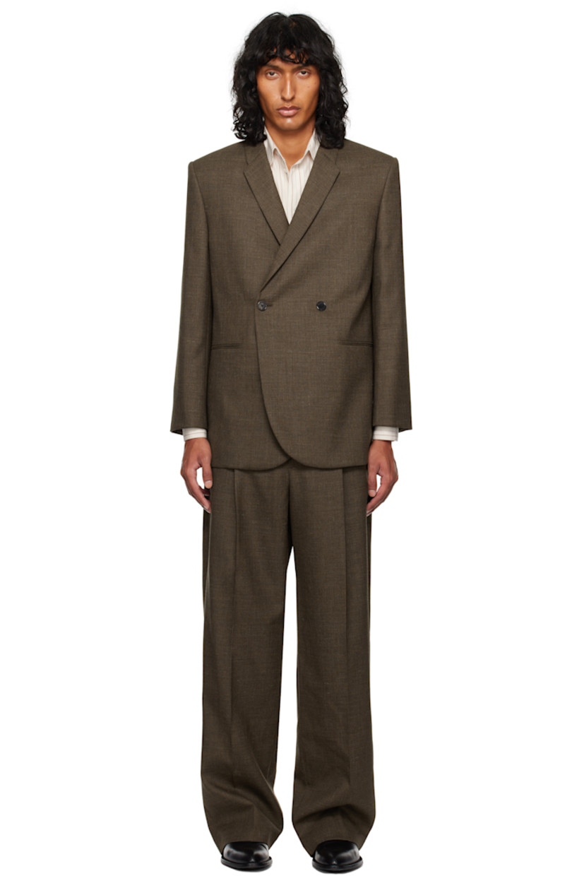 Wool serge blazer.

· Notched lapel
· Button closure
· Welt pockets
· Padded shoulders
· Four-button surgeon's cuffs
· Twin vents at back hem
· Welt pockets at interior
· Silk habotai lining

Supplier color: Brown melange