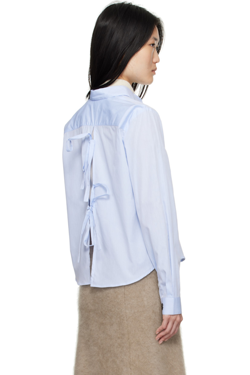 Cotton poplin shirt.

· Spread collar
· Button closure
· Logo embroidered at front
· Cropped shirttail hem
· Single-button barrel cuffs
· Self-tie straps at vented back

Supplier color: Dusty blue