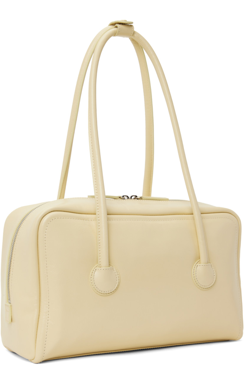 Buffed leather shoulder bag in beige.

· Press-stud tab at rolled shoulder straps
· Logo embossed at face
· Two-way zip closure
· Zip and patch pockets at interior
· Logo-woven twill lining
· H7.5" x W12.5" x D3.5"

Supplier color: Blond wood glossy plain