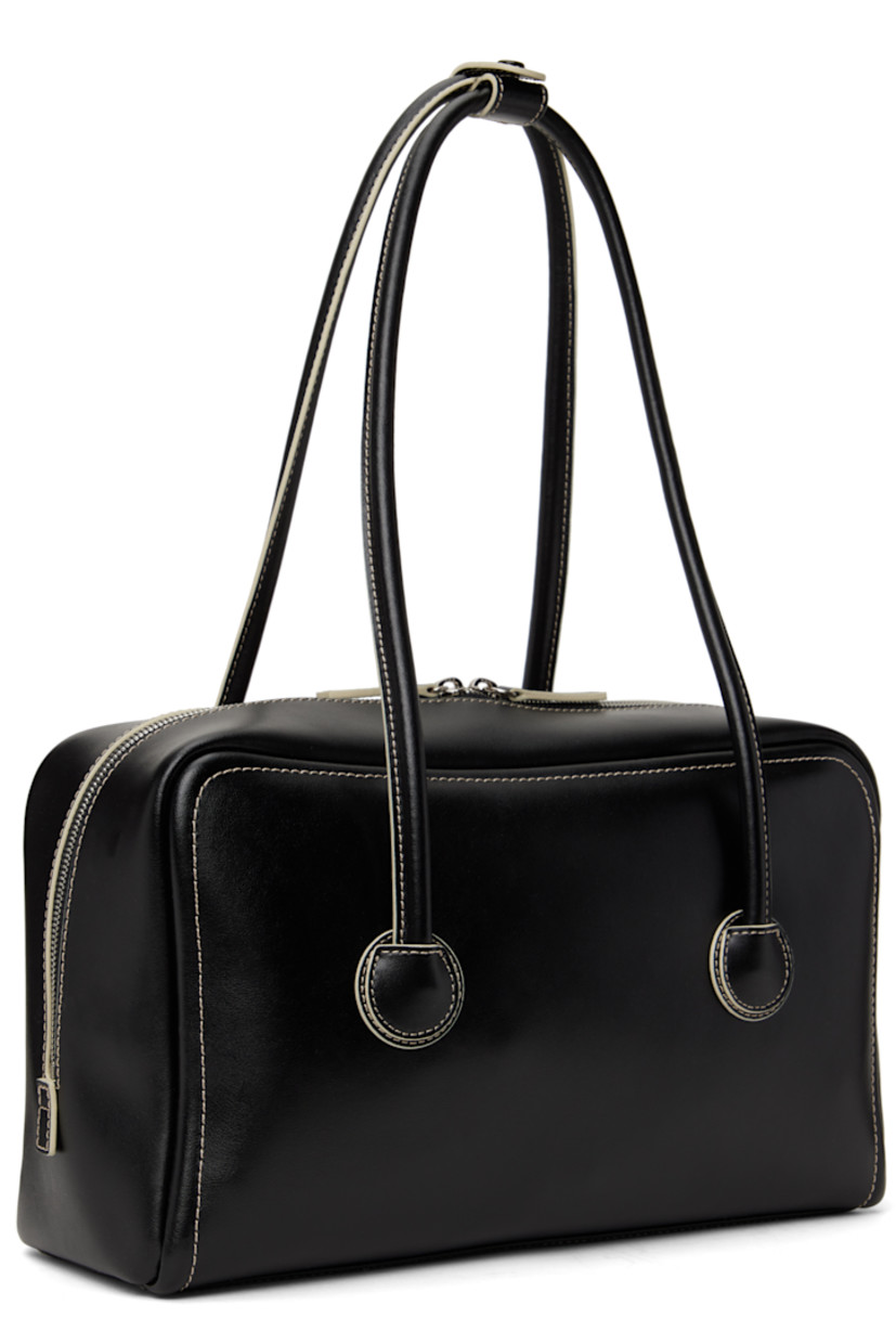 Buffed leather shoulder bag in black.

· Press-stud tab at rolled shoulder straps
· Logo embossed at face
· Two-way zip closure
· Zip and patch pockets at interior
· Logo-woven twill lining
· Contrast stitching in off-white
· H7.5" x W12.5" x D3.5"

Supplier color: Black plain