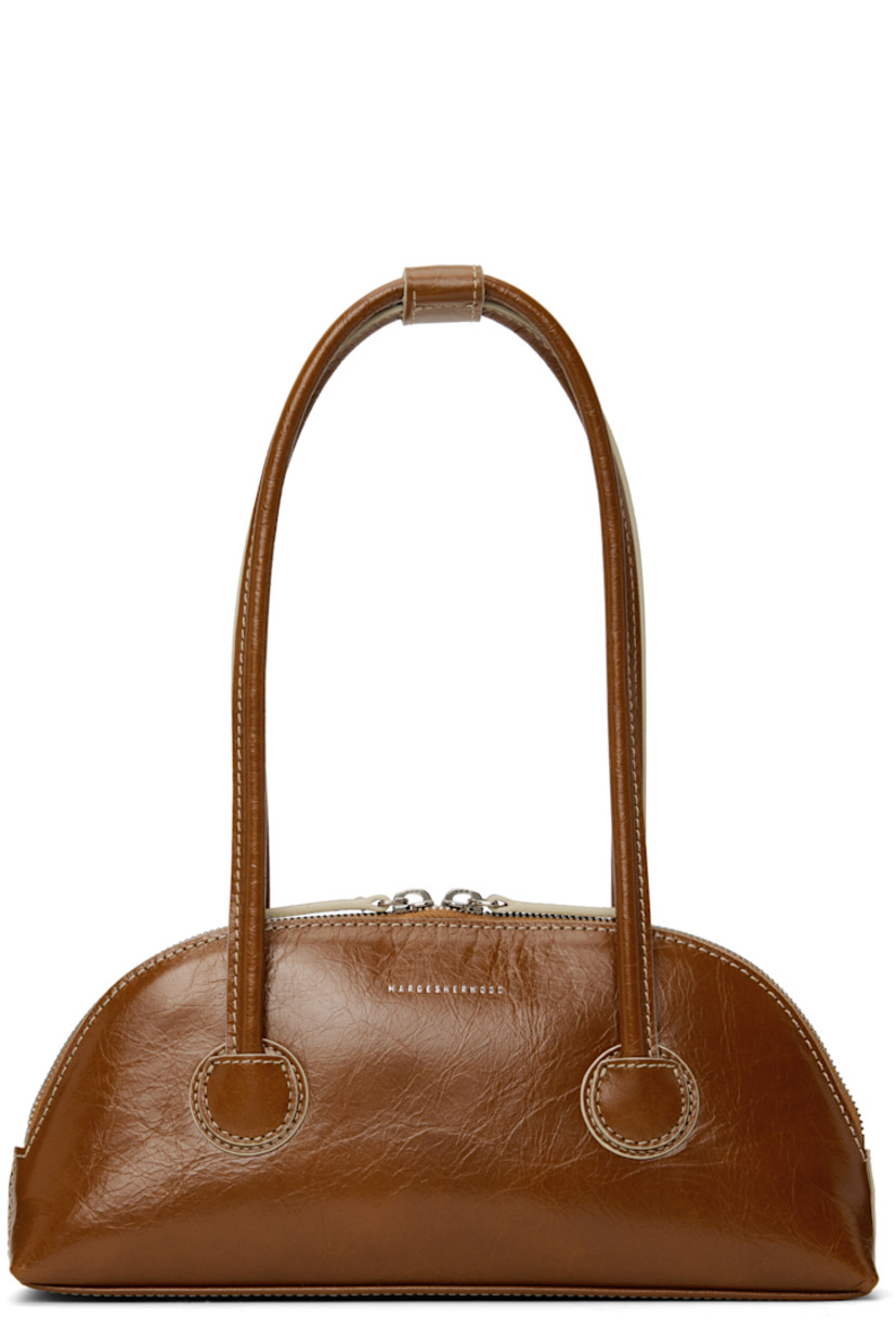 Polished crinkled leather shoulder bag in brown.

· Press-stud tab at rolled shoulder straps
· Logo stamp at face
· Two-way zip closure
· Logo-woven twill lining
· Contrast stitching in off-white
· H5" x W10.5" x D2"

Supplier color: Brown crinkle