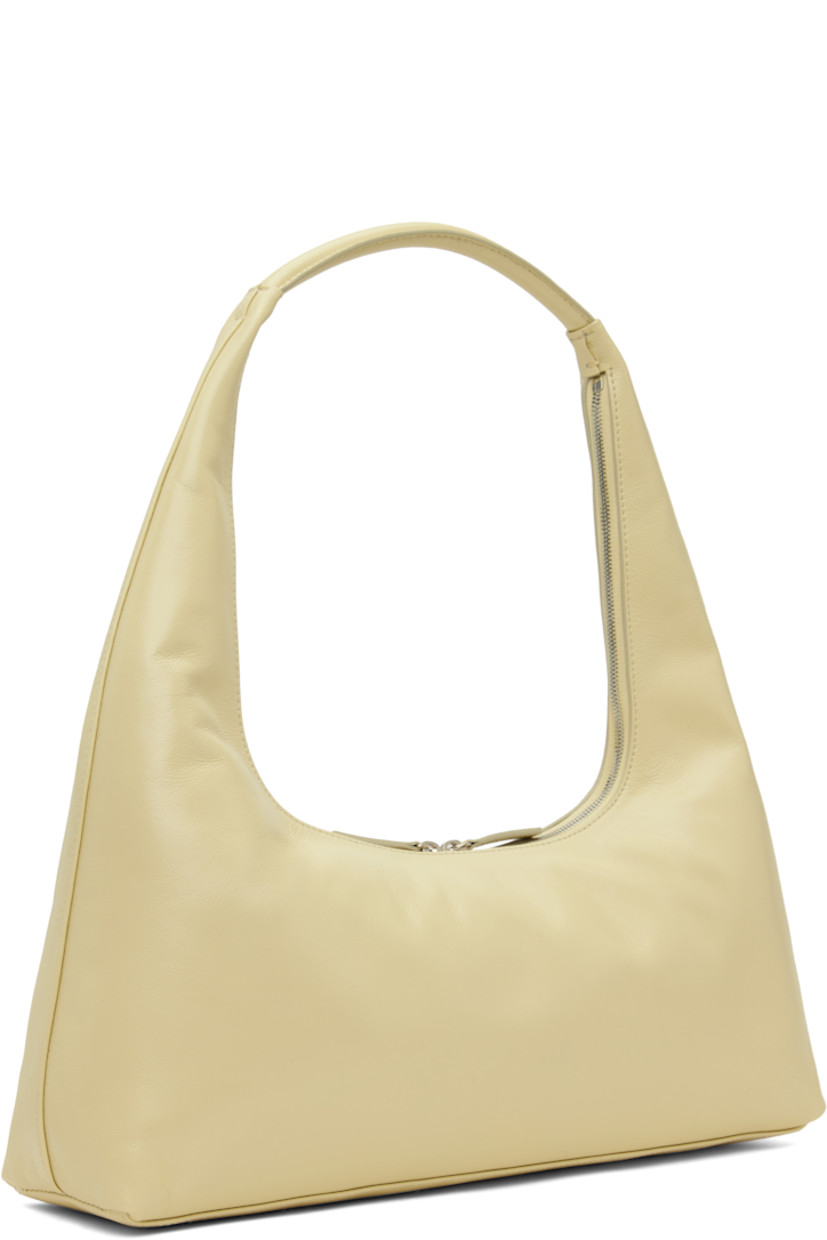 Buffed leather shoulder bag in beige.

· Fixed shoulder strap
· Logo stamp at face
· Two-way zip closure
· Patch pocket at interior
· Logo-patterned moiré lining
· Logo-engraved antiqued silver-tone hardware
· H7" x W16" x D3.5"

Supplier color: Blond wood glossy plain