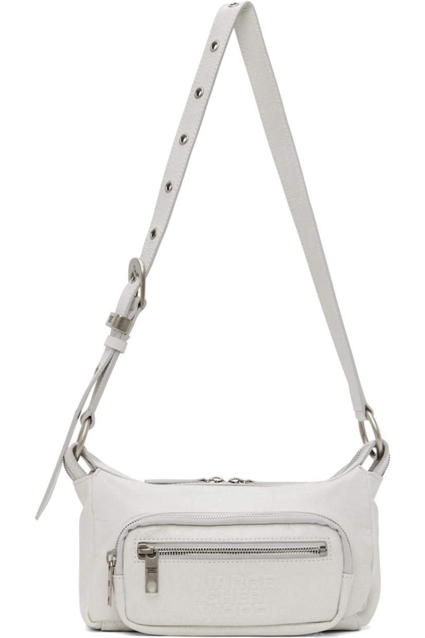 Cracked leather shoulder bag in off-white.

· Adjustable pin-buckle shoulder strap
· Zip pockets at face
· Logo embossed at face
· Two-way zip closure
· Zip and patch pocket at interior
· Logo-patterned moiré lining
· Logo-engraved antiqued silver-tone hardware
· H5" x W9" x D3"

Supplier color: Off white cracked
