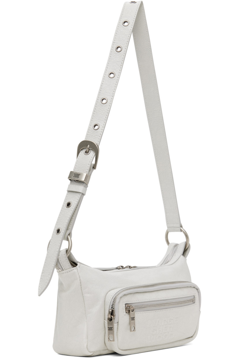 Cracked leather shoulder bag in off-white.

· Adjustable pin-buckle shoulder strap
· Zip pockets at face
· Logo embossed at face
· Two-way zip closure
· Zip and patch pocket at interior
· Logo-patterned moiré lining
· Logo-engraved antiqued silver-tone hardware
· H5" x W9" x D3"

Supplier color: Off white cracked