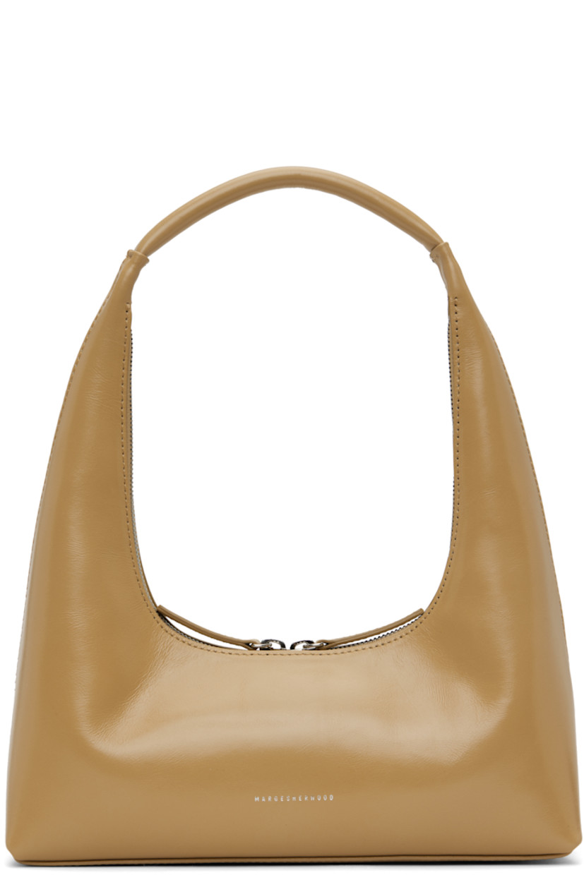 Polished crinkled leather shoulder bag in beige.

· Integrated shoulder strap
· Logo stamp at face
· Two-way zip closure
· Card slot at interior
· Logo-woven twill lining
· H4" x W10.25" x D2.75" 
· Total height: H12.25"

Supplier color: Beige crinkle