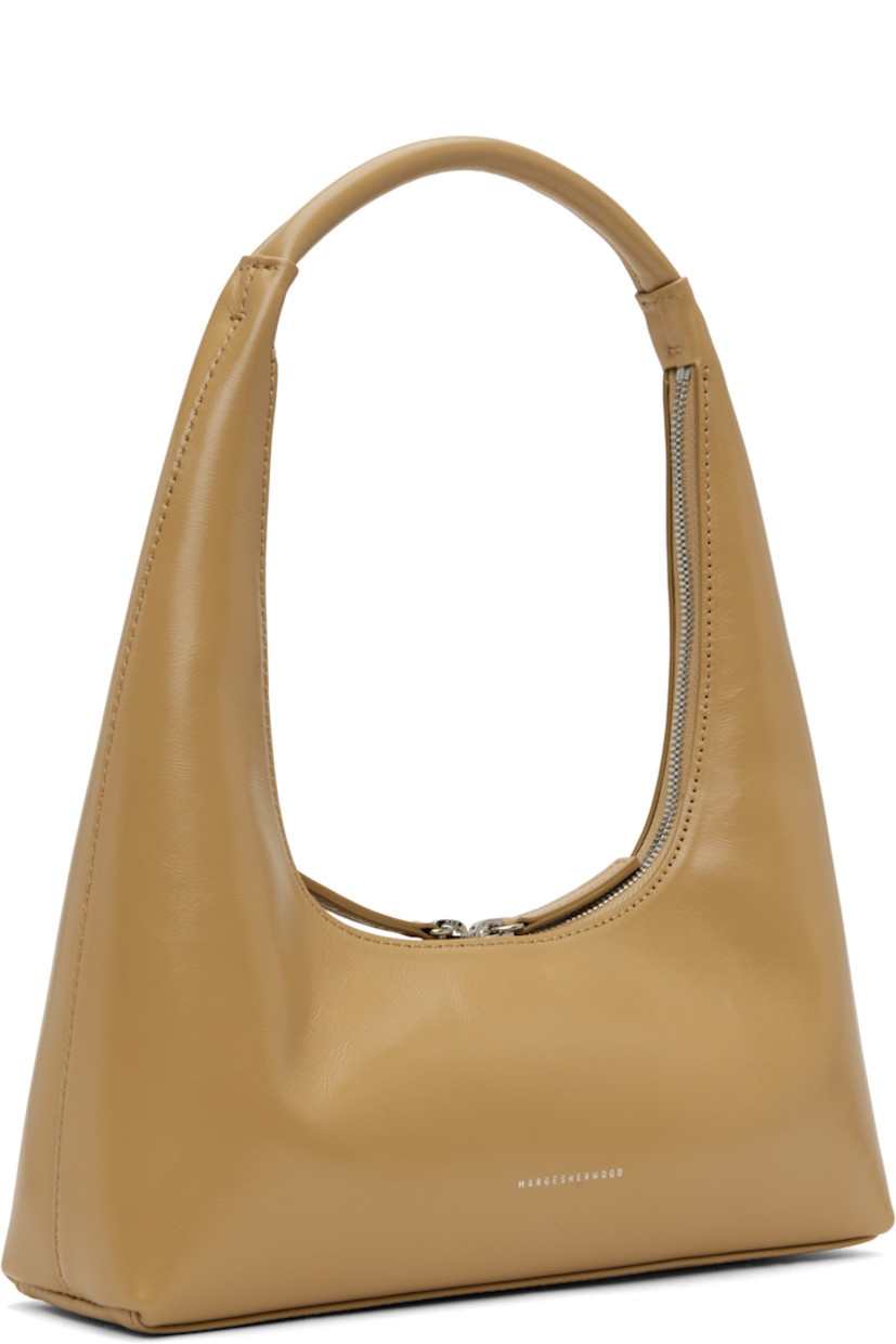 Polished crinkled leather shoulder bag in beige.

· Integrated shoulder strap
· Logo stamp at face
· Two-way zip closure
· Card slot at interior
· Logo-woven twill lining
· H4" x W10.25" x D2.75" 
· Total height: H12.25"

Supplier color: Beige crinkle