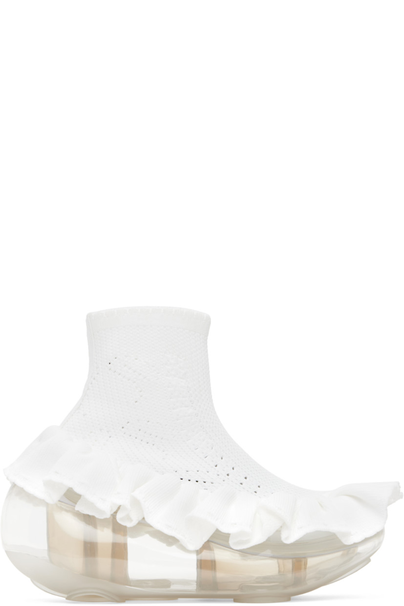 High-top knit sneakers in white.

· Perforated detailing throughout
· Scalloped edge at elasticized collar
· Ruffled trim at welt
· Transparent rubber platform midsole
· Treaded rubber sole
· Platform: H2"
· Heel: H4"

Supplier color: White