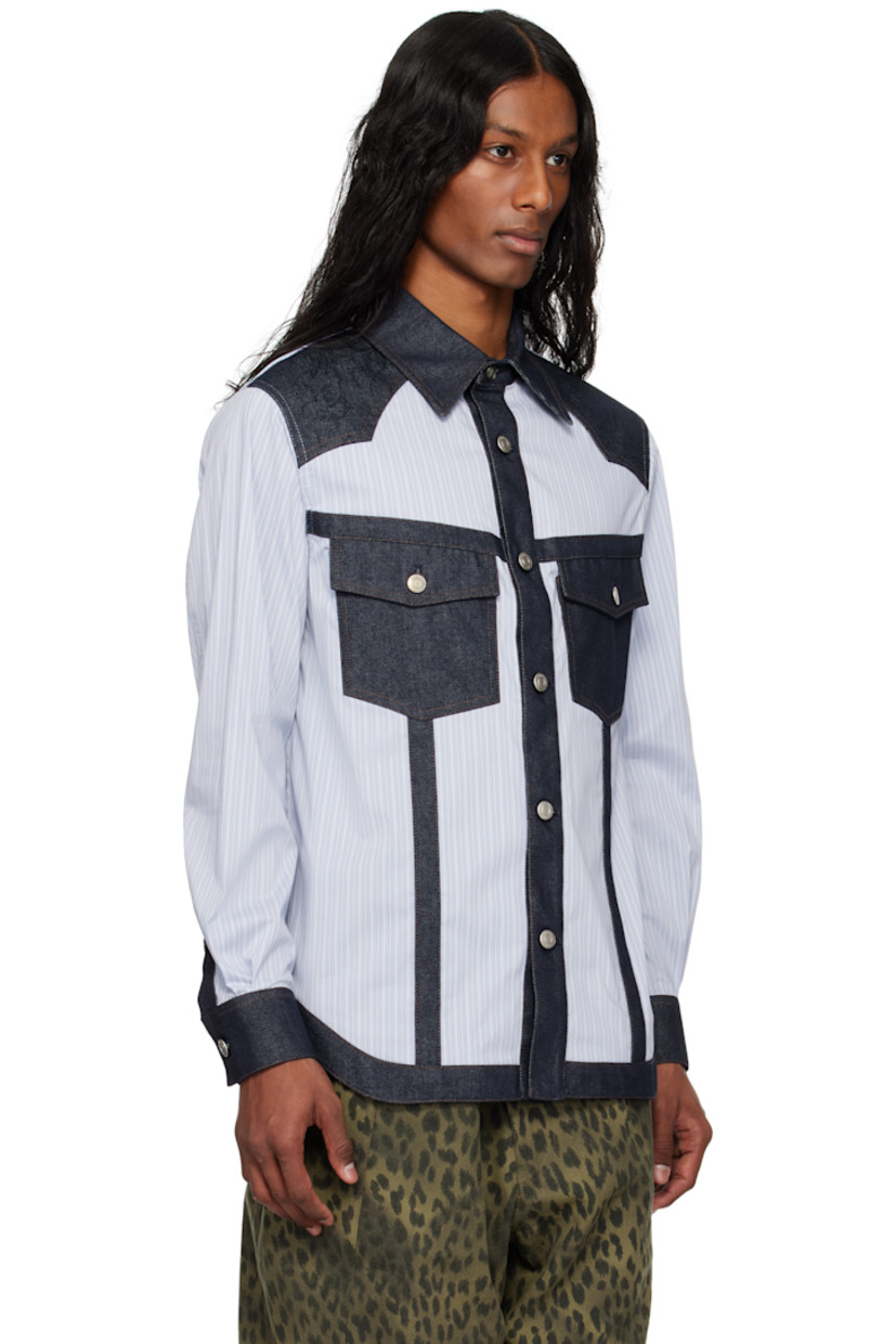 Stretch cotton-blend poplin and non-stretch denim shirt. Stripes throughout.

· Spread collar
· Button closure
· Graphic topstitching at front yoke
· Flap pockets at chest
· Shirttail hem
· Pleats at buttoned barrel cuffs
· Logo plaque at back collar
· Logo-engraved silver-tone hardware
· Contrast stitching in brown

Supplier color: Blue